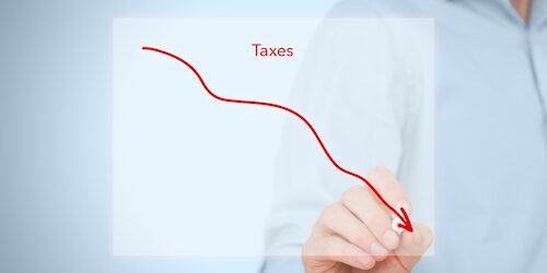 Taxes optimization business concept. Businessman draw simple graph with descending curve.